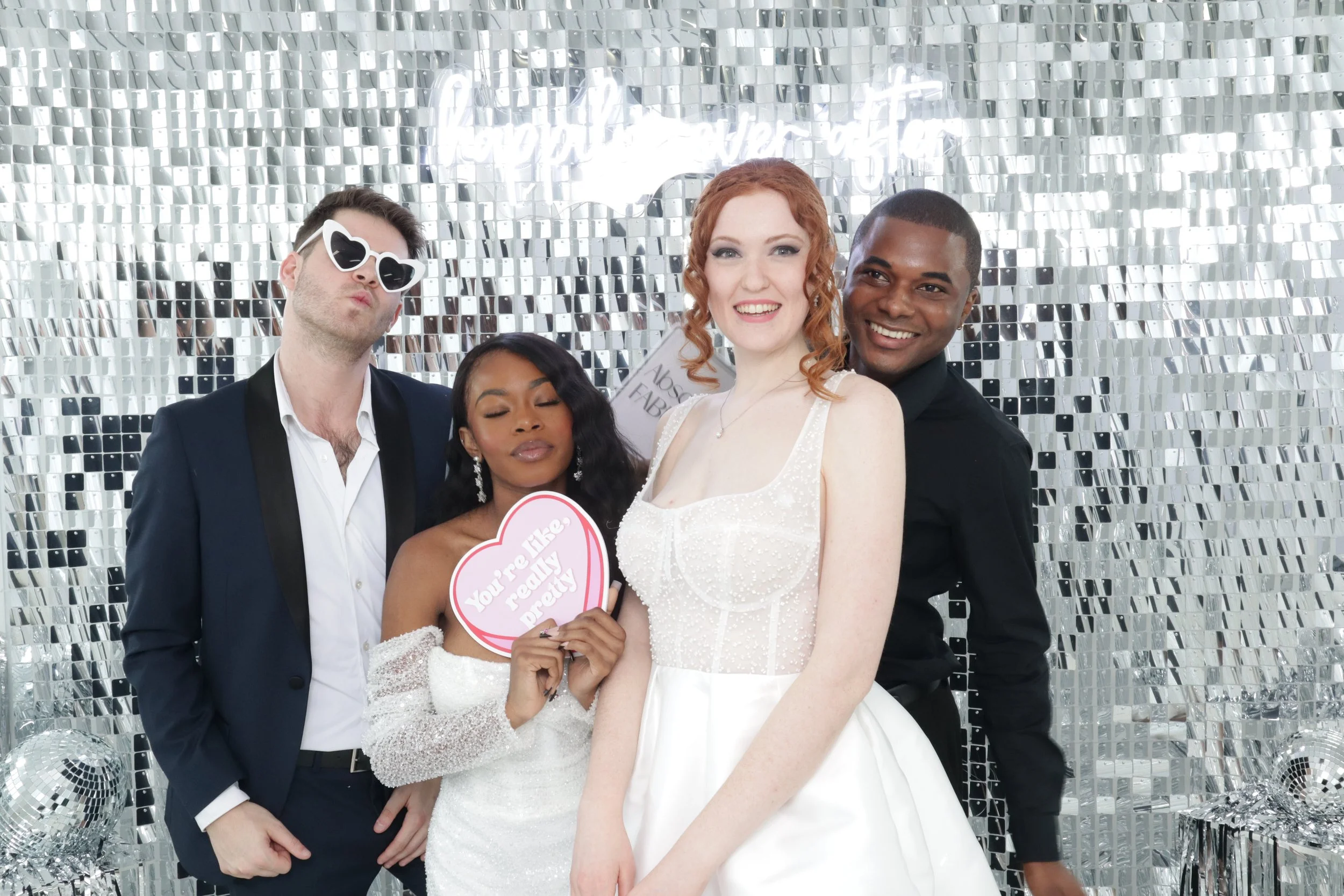 Guests posing in front of an event backdrop