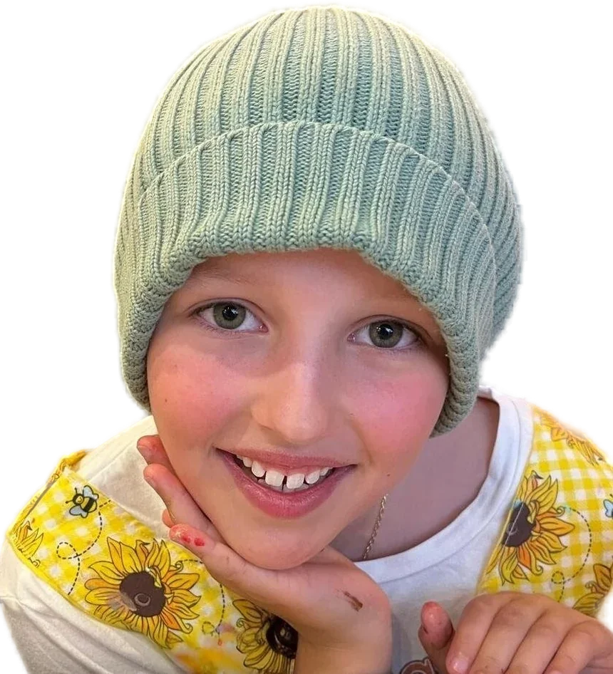 Beatrix smiling, resting her chin on her hand