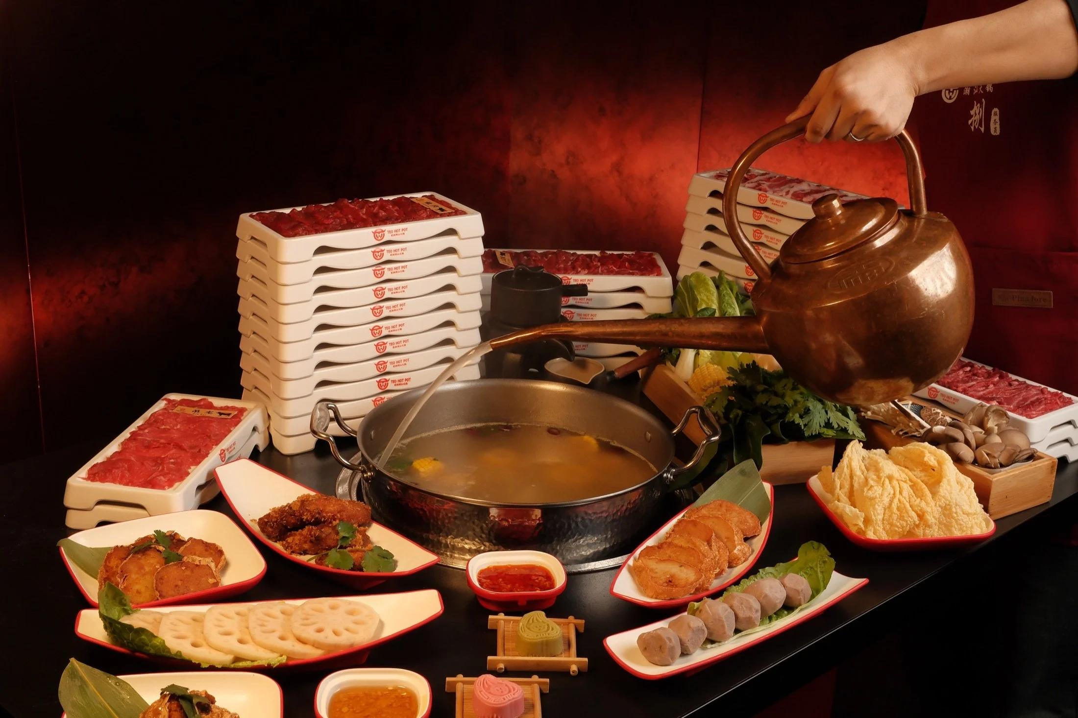 Broth being poured at a TEO Hot Pot table