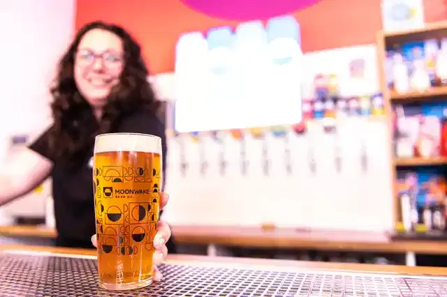 Sarah behind the bar at Moonwake with a pint