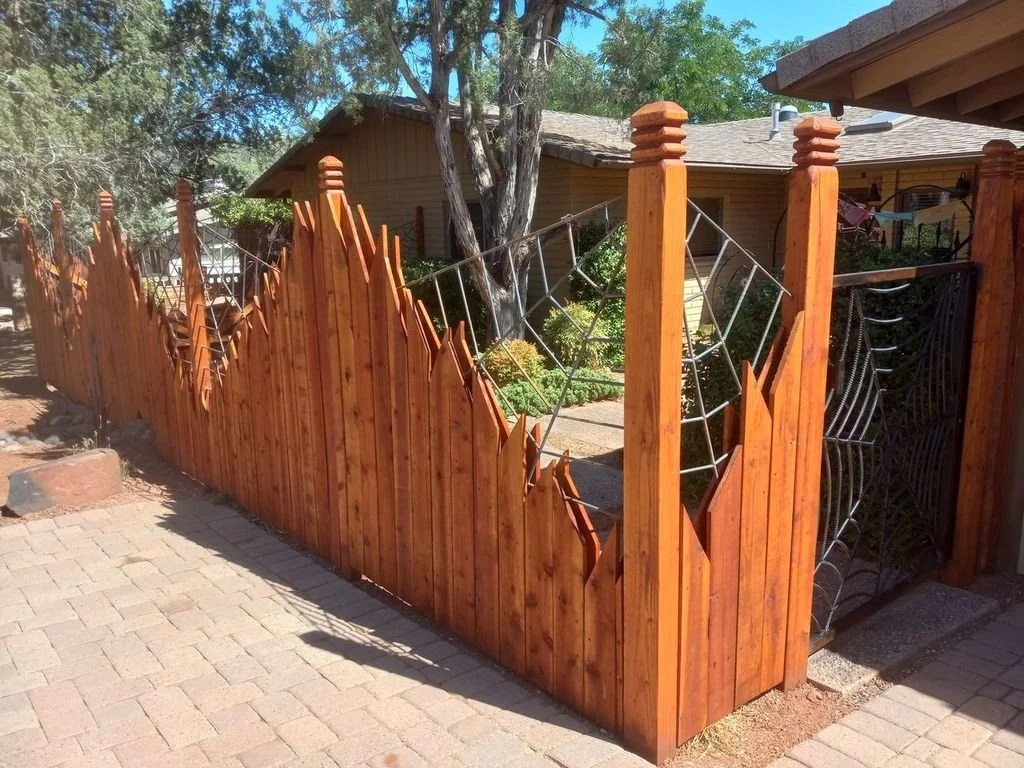 Custom wood fence with steel spiderweb gate, full view