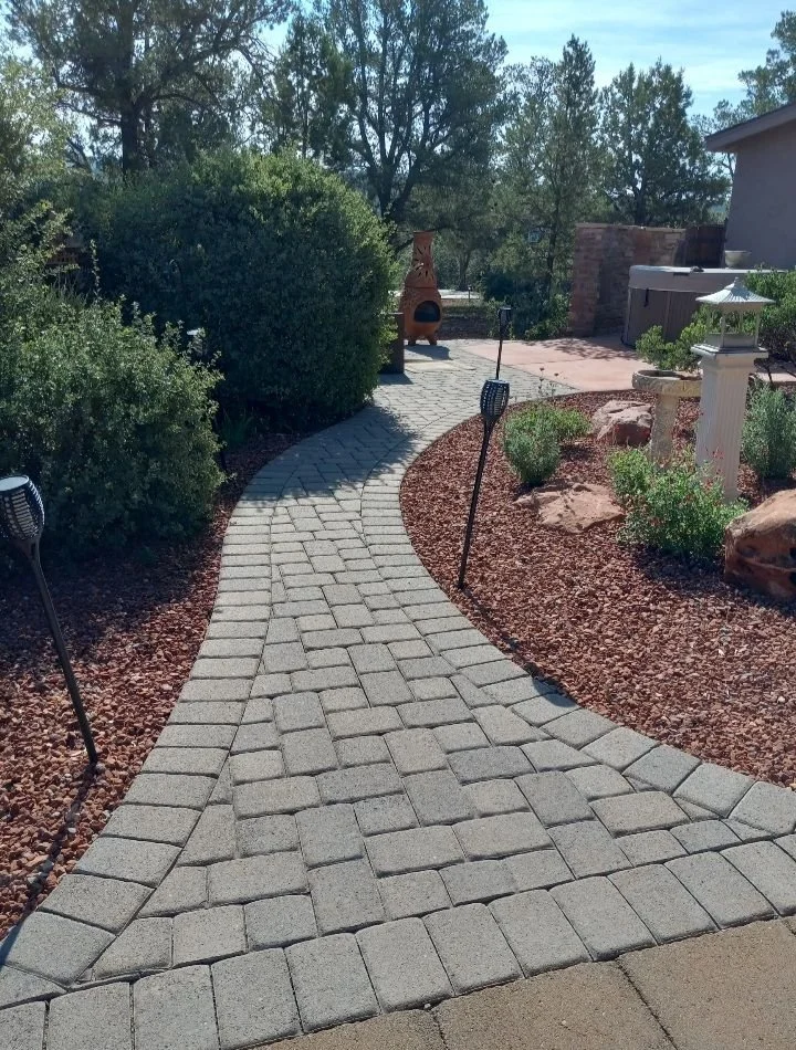 Curving stone paver walkway through a landscape