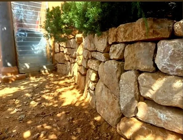 Stone wall integrated into a natural landscape