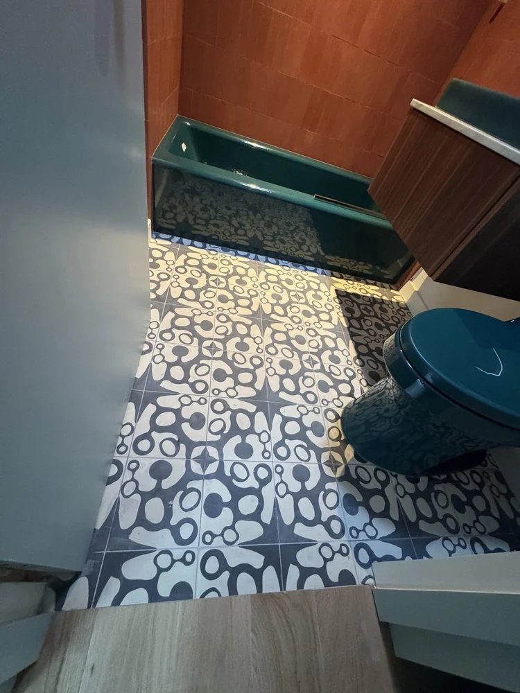 Terracotta and teal bathroom installation — project view.