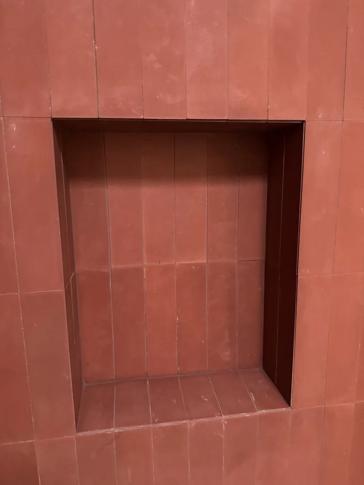 Terracotta and teal bathroom installation — project view.
