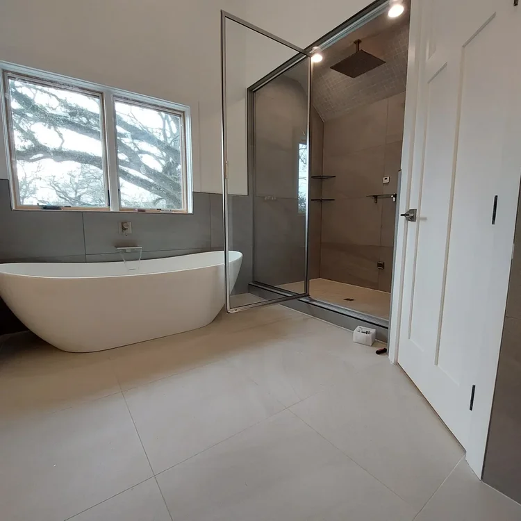 Freestanding tub and glass shower — EC Construction project photograph.