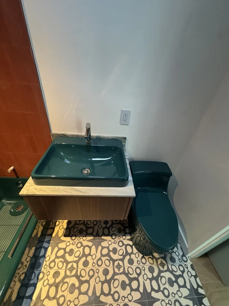 Terracotta and teal bathroom installation — project view.