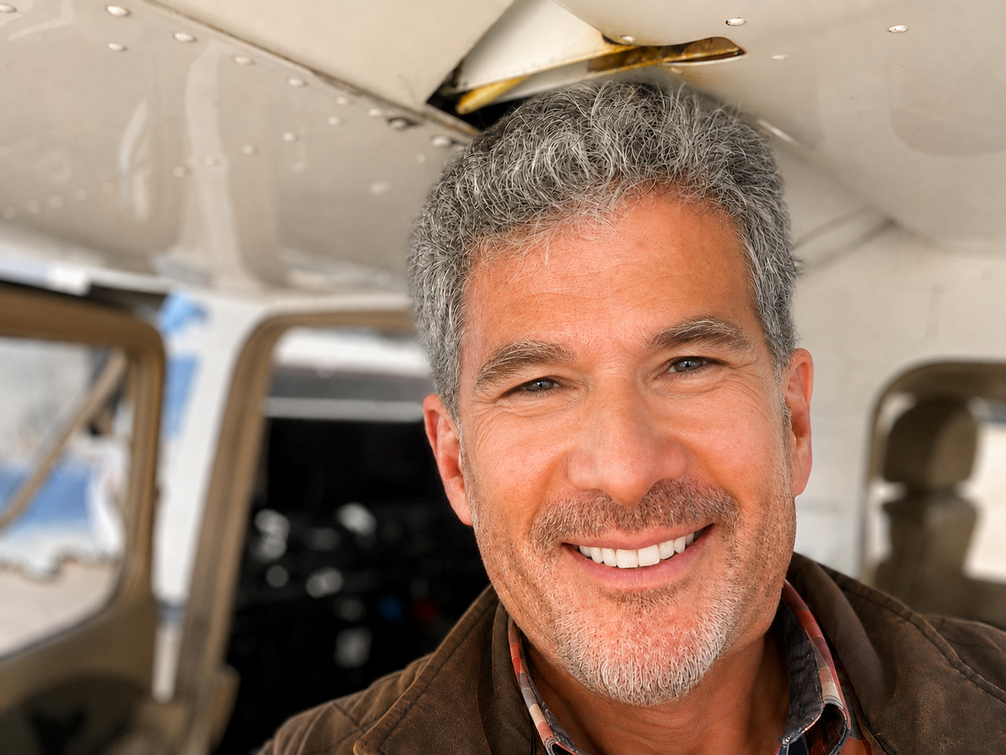 Portrait of Jay Allan Shears inside an aircraft cockpit.