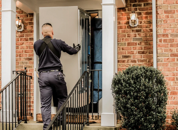 Delivery professional bringing a large appliance into a customer’s home
