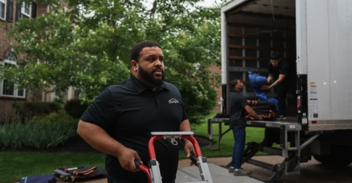 Home delivery crew unloading a box truck at a residence