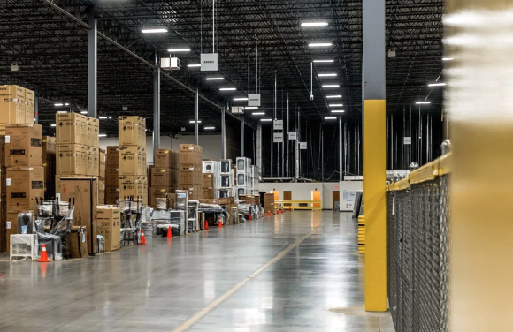 Appliances and packaged goods staged in a distribution warehouse