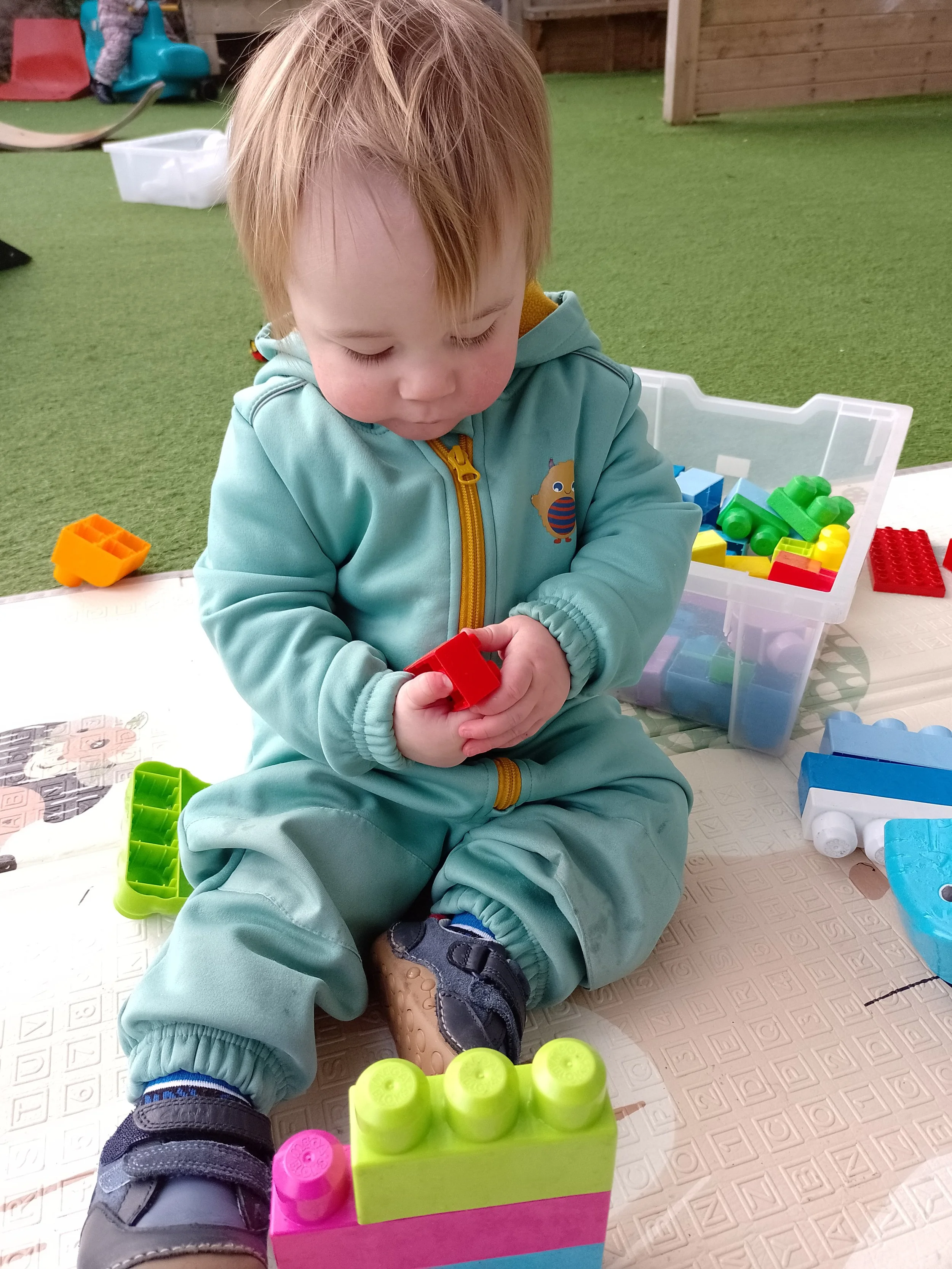 A young child playing with building blocks at Rydal Day Nursery