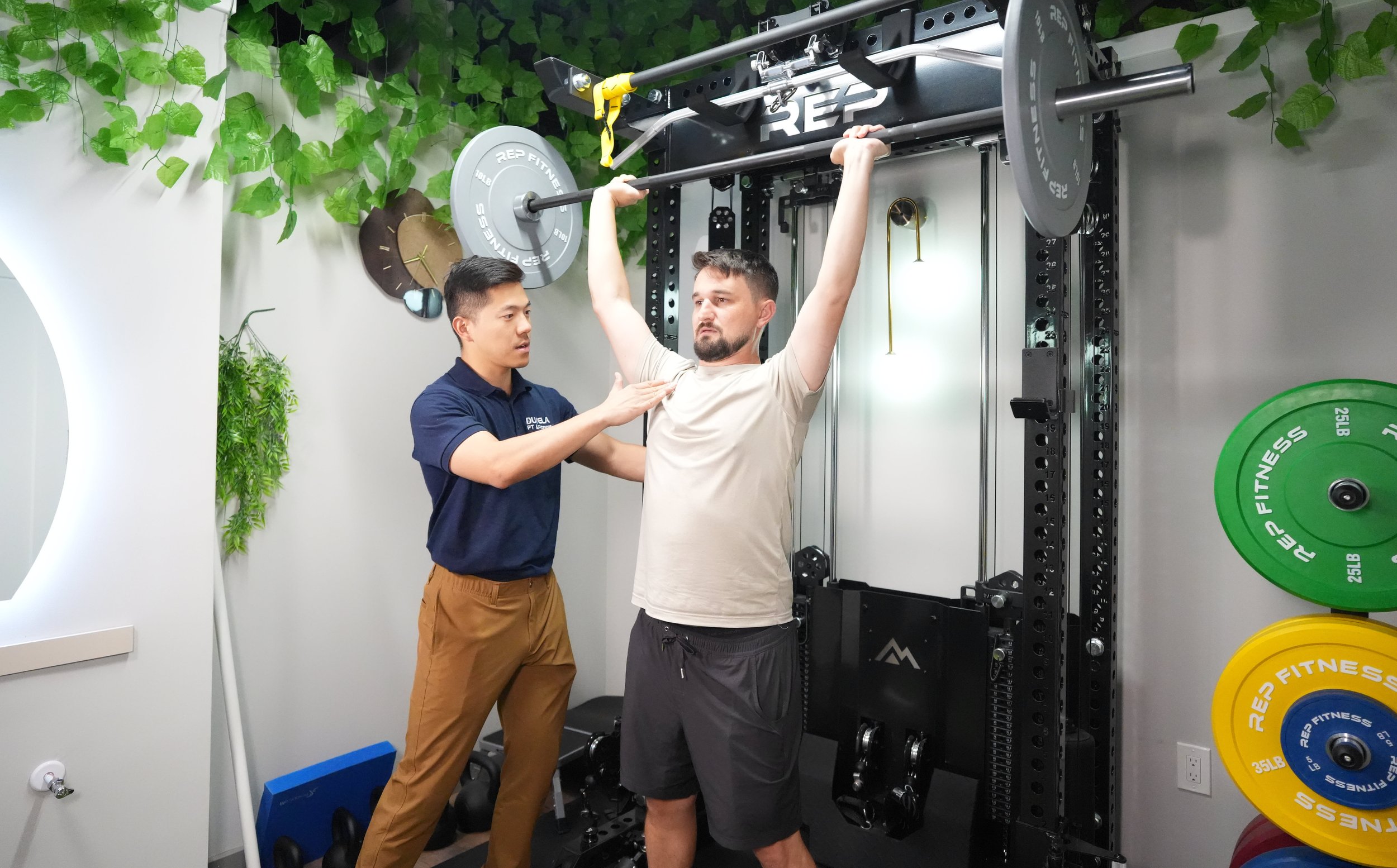 Dr. Gong working with a patient on strength training.