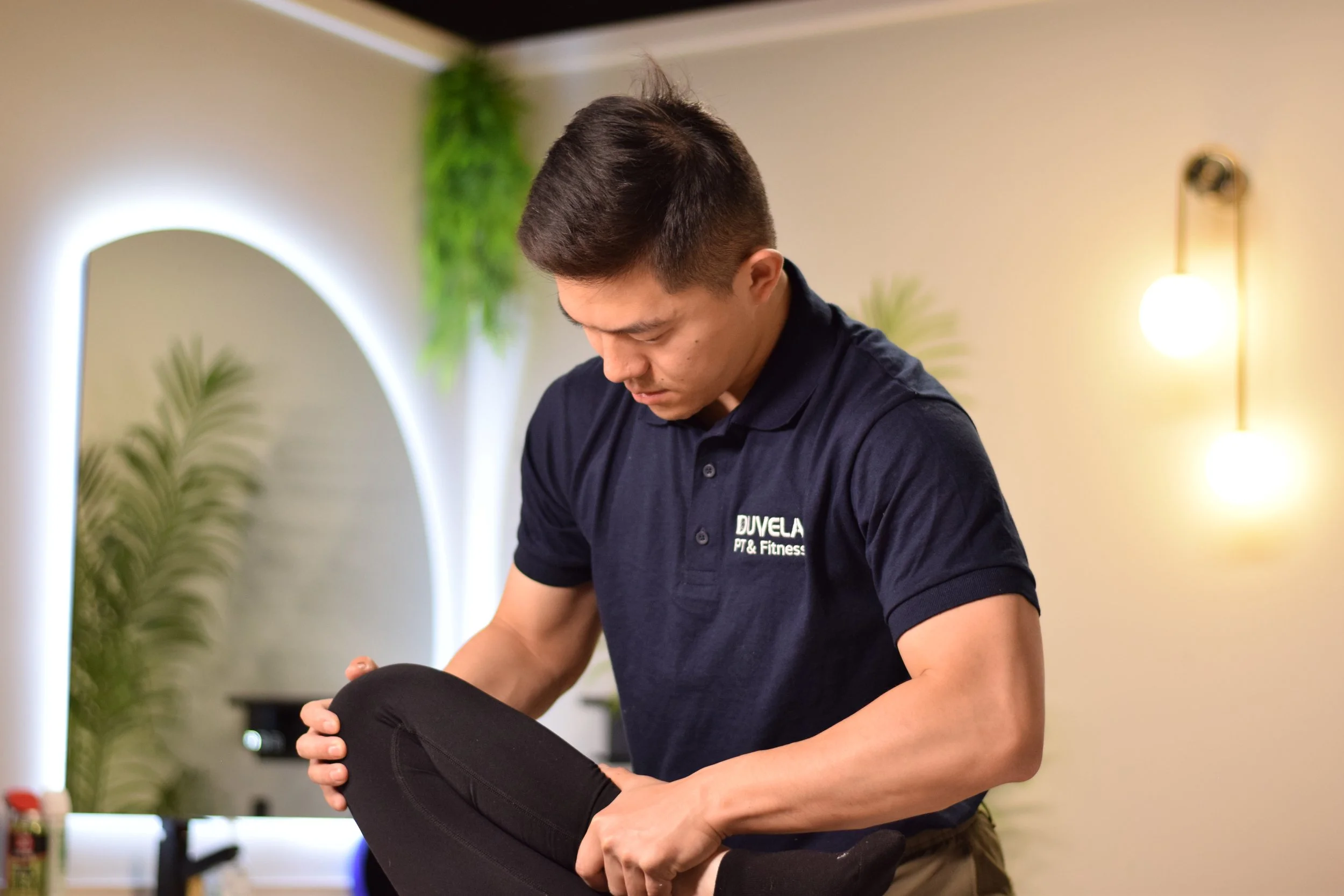 Dr. Gong assessing a person's knee movement