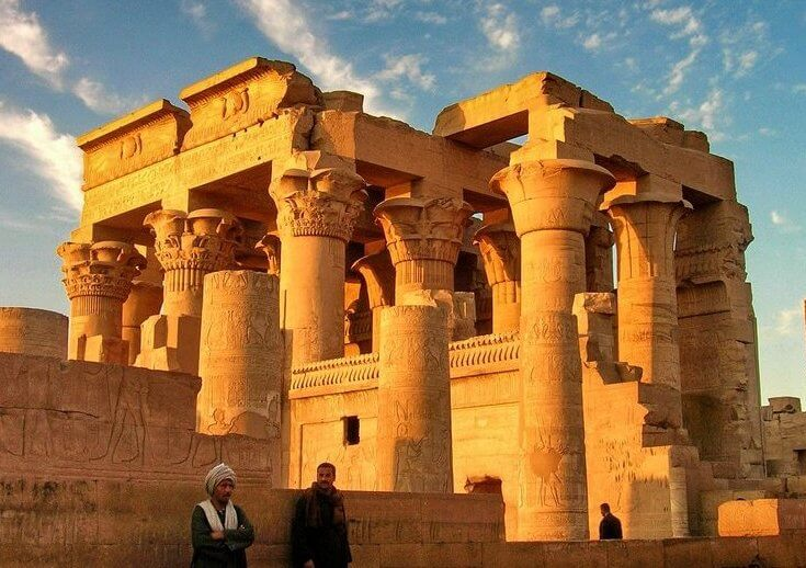 Carved temple columns glowing in warm golden light