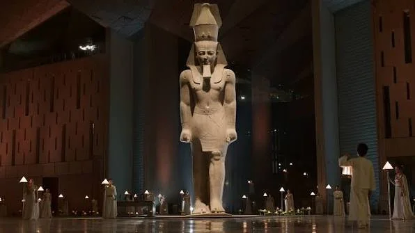 A monumental ancient Egyptian statue inside the Grand Egyptian Museum