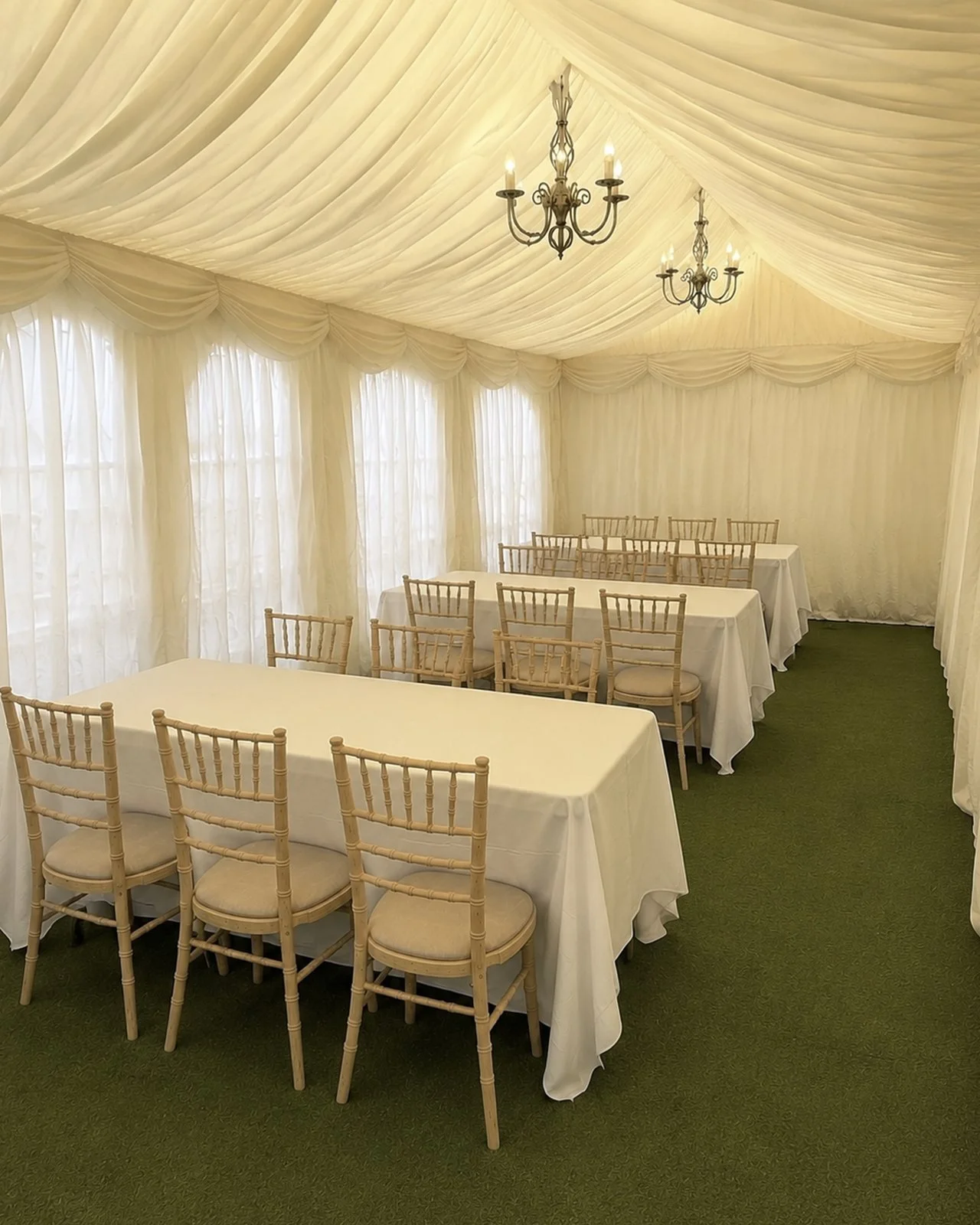 Ivory garden marquee interior with dining tables and Chiavari chairs