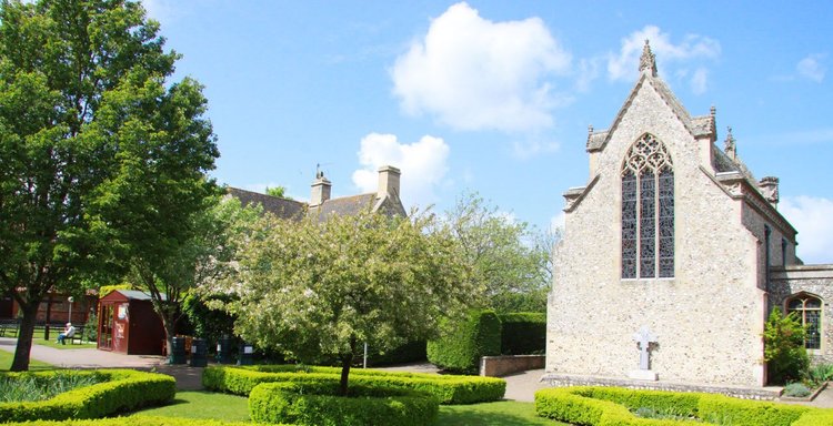 The flint exterior of the Slipper Chapel beside the gardens of Walsingham's Catholic shrine.