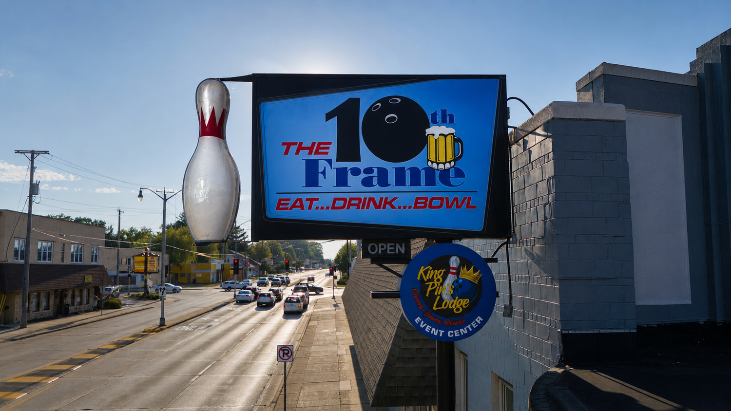 The 10th Frame street sign with the giant bowling pin over West Wisconsin Avenue, with the King Pin's Lodge event center badge.