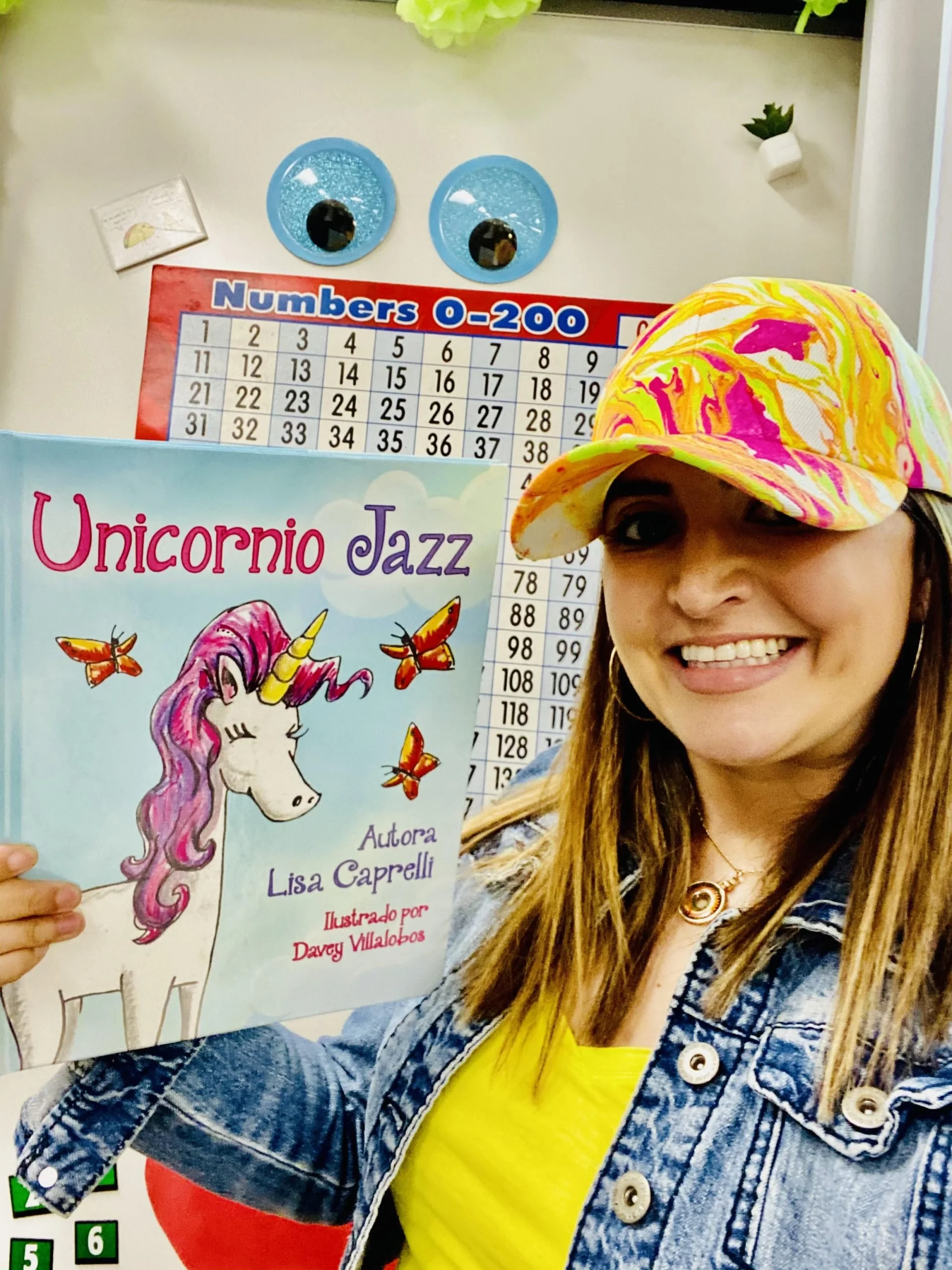 Bilingual teacher Pam Quevedo holding Unicornio Jazz in her classroom