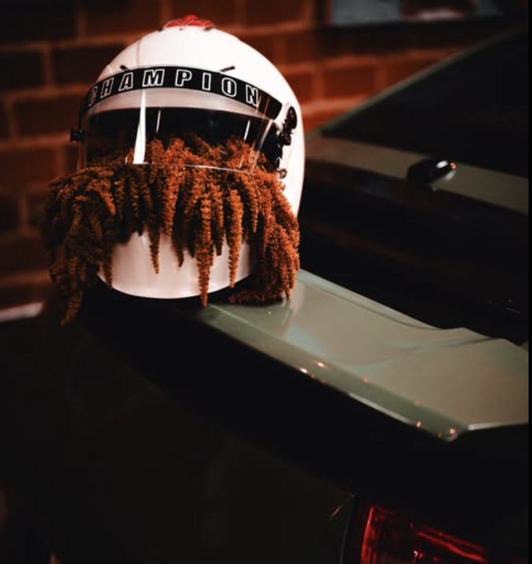 Floral fringe detail on a custom cap displayed on a car