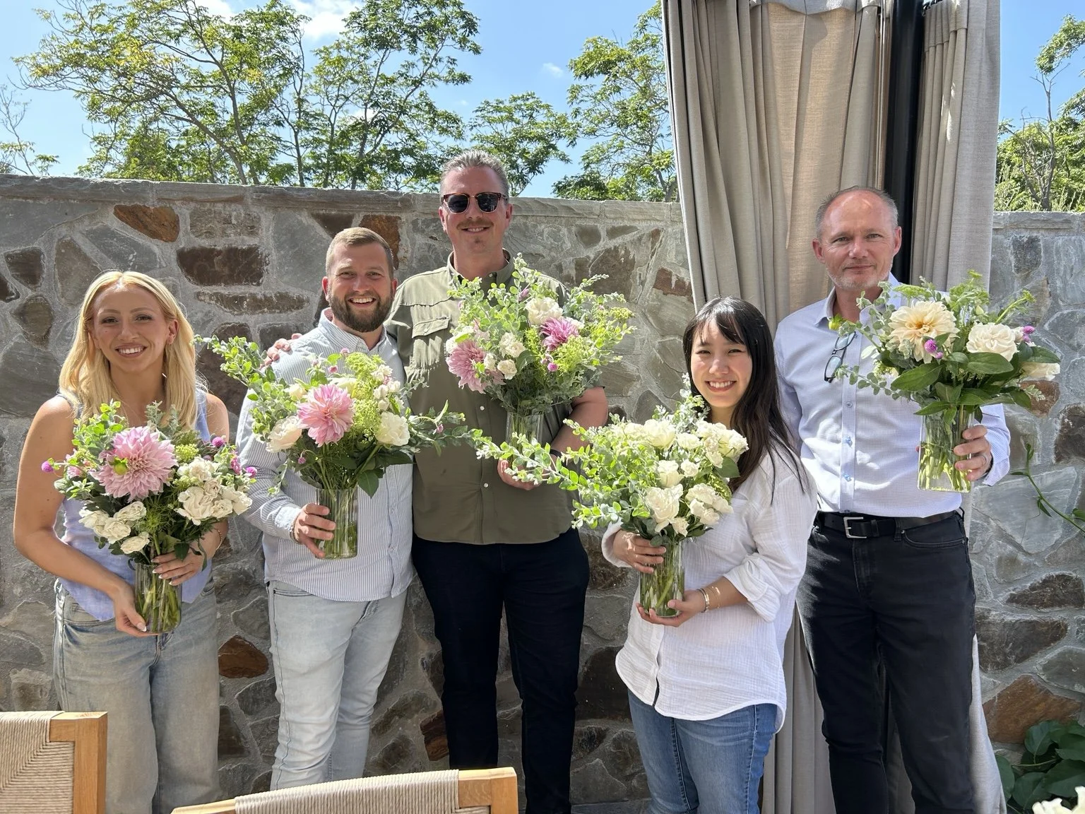 Executive workshop participants holding their floral arrangements in Los Olivos