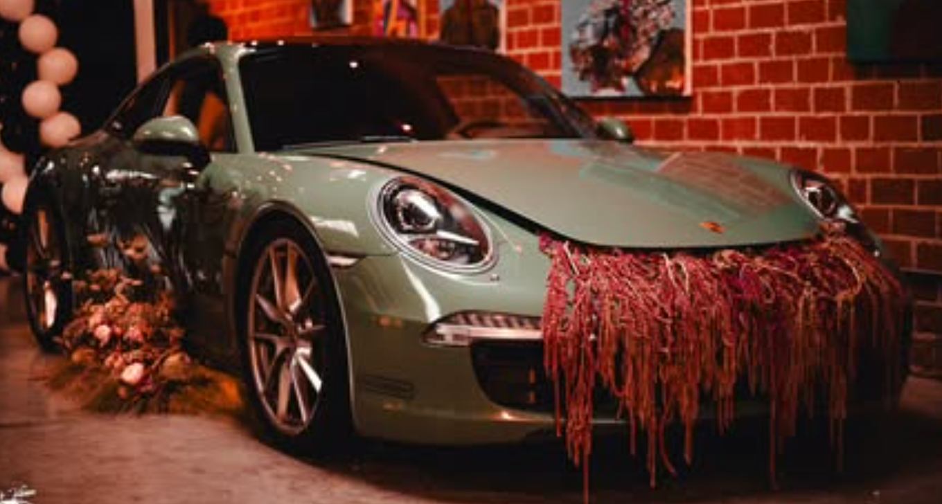 Porsche with a cascading red floral installation