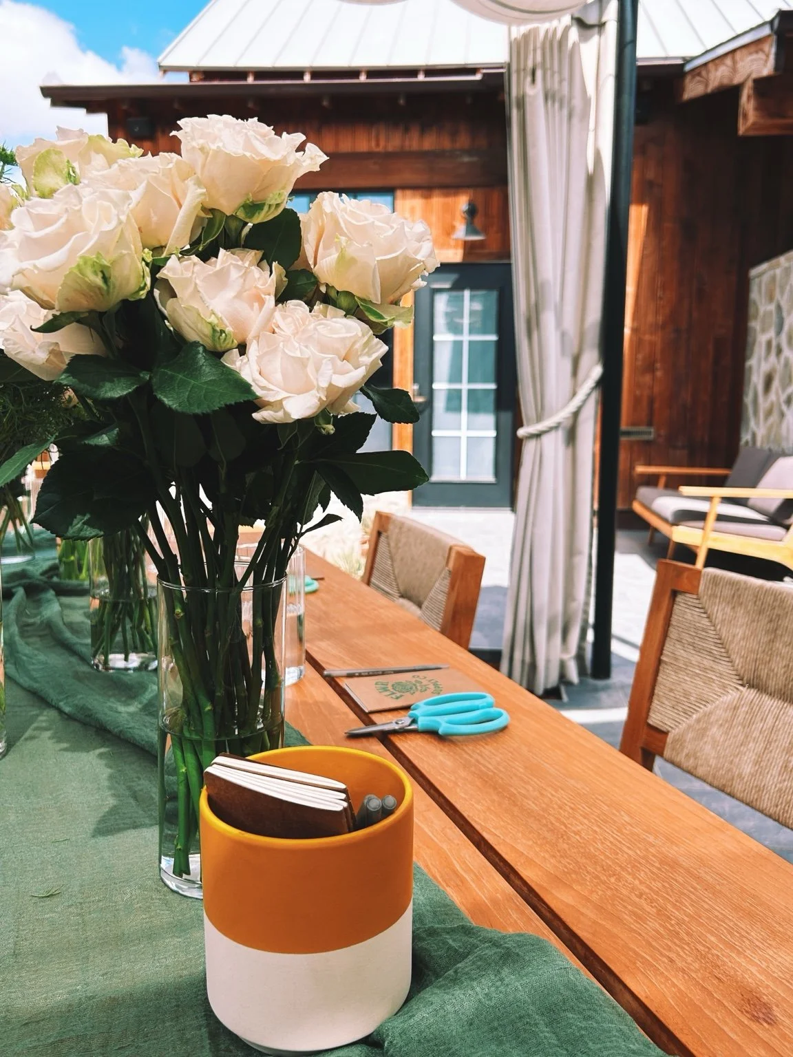 White roses and a yellow cup at the Los Olivos executive workshop