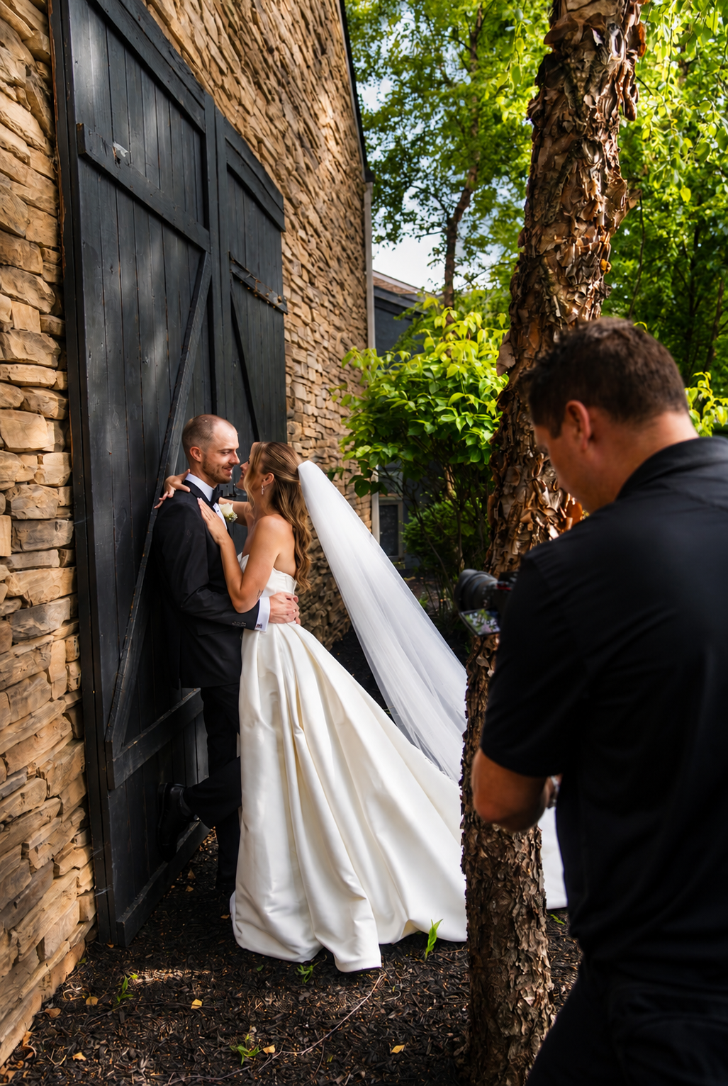 Vows & Ember filming a bride and groom beside a stone venue