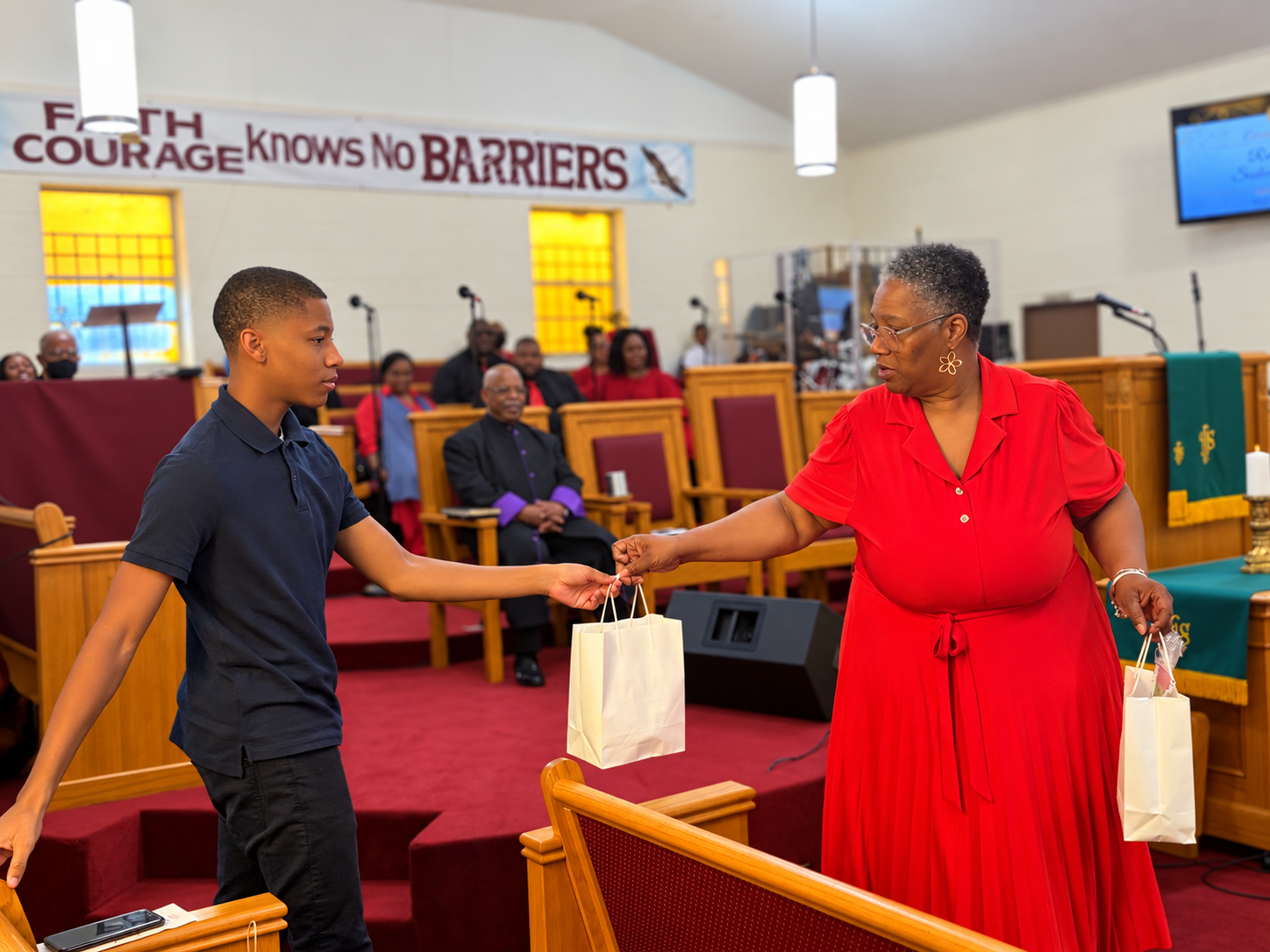 Woman handing a gift to a boy at Williams Temple