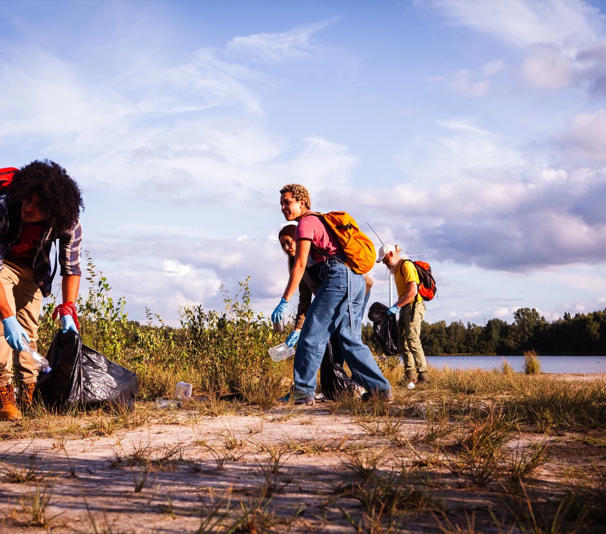 Volunteers collecting litter during a lakeside conservation project