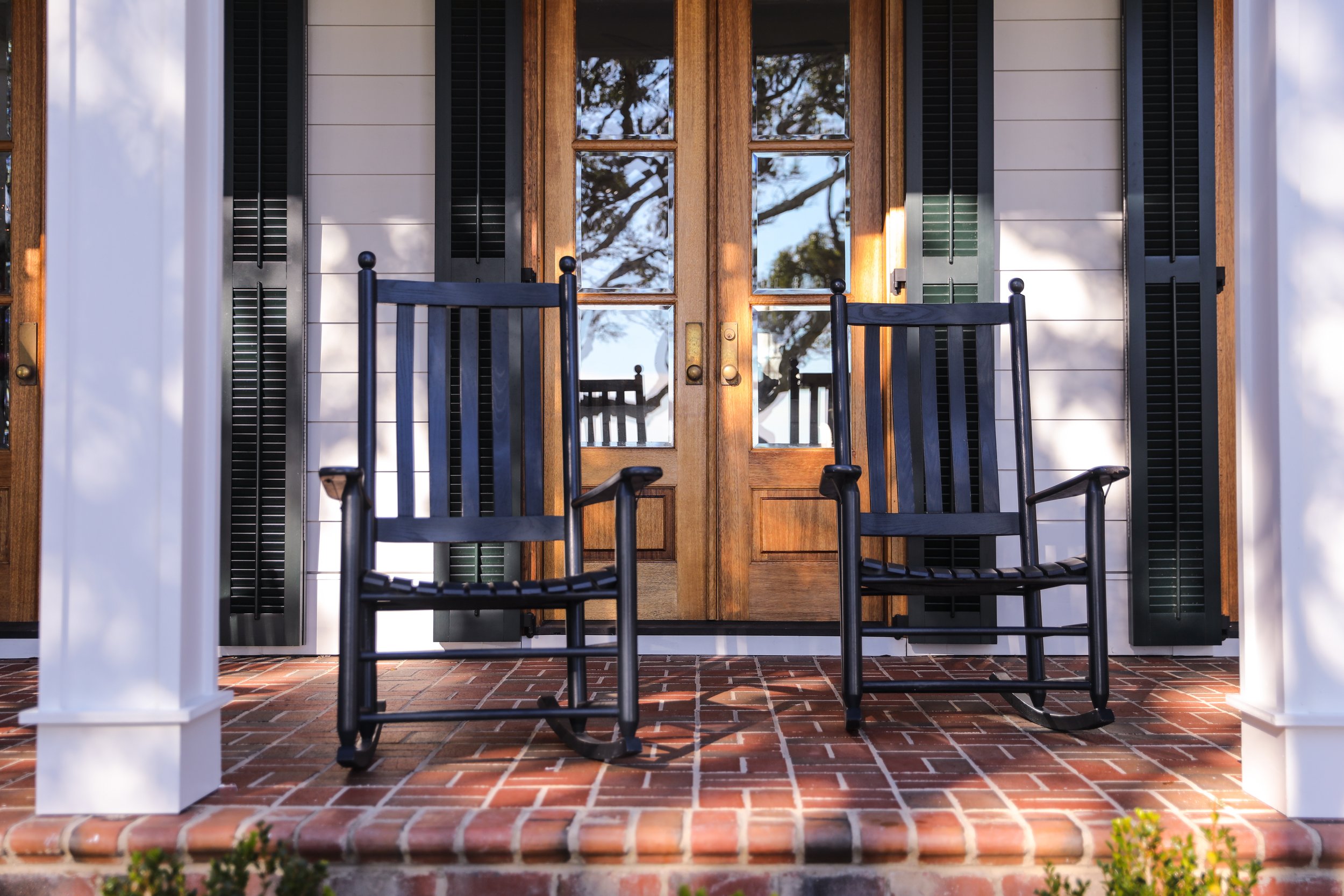 Two rocking chairs on a sunlit Southern porch