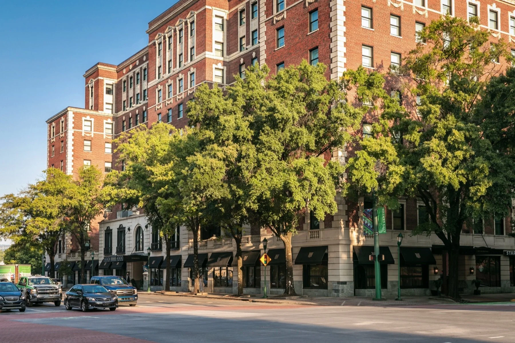The brick exterior of The Read House Hotel on a tree-lined street in downtown Chattanooga