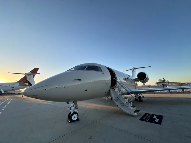 Large-cabin business jet on the ramp at sunrise after a full detail