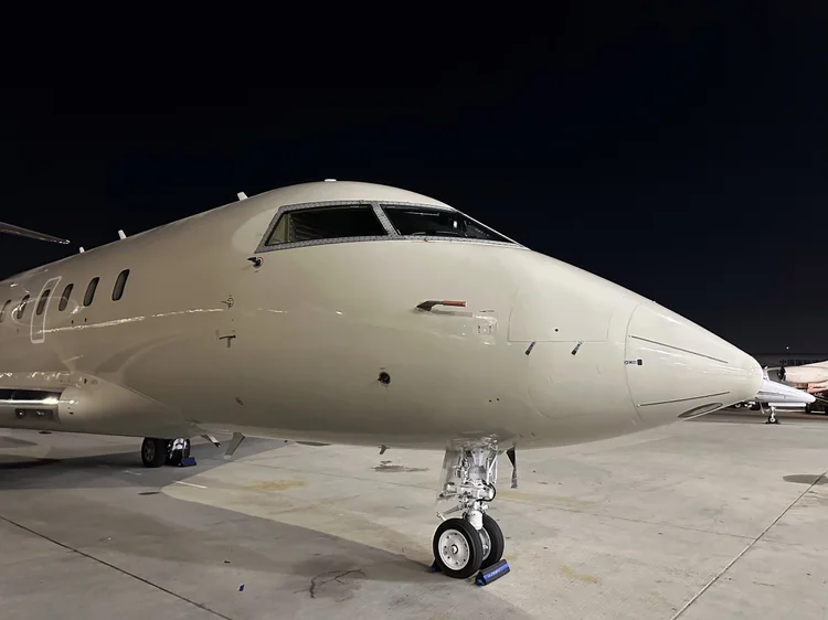 Large-cabin jet nose on the ramp at night after detailing