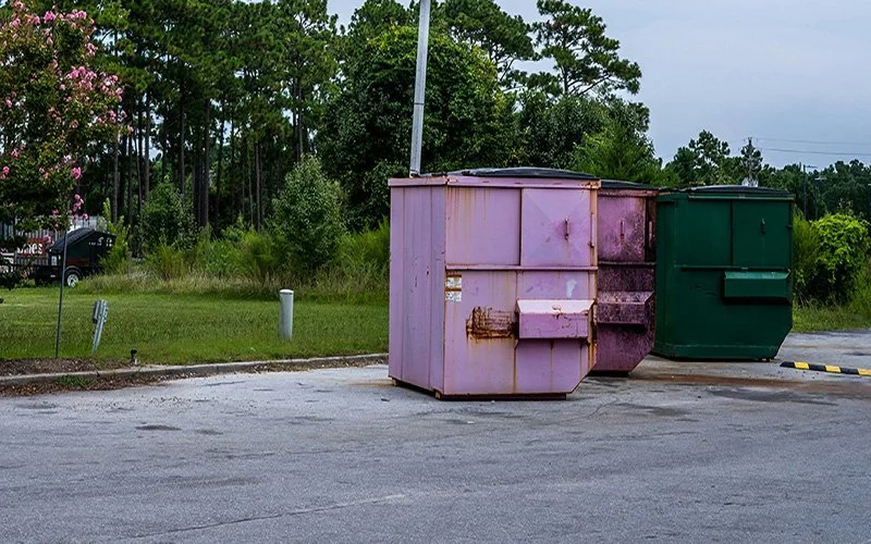 Commercial dumpster and trash area for professional pressure washing and exterior cleaning