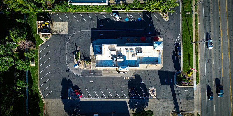 Aerial view of a commercial drive-through and parking area maintained by American Mobile Wash
