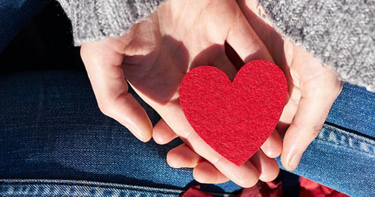 Hands holding a red heart