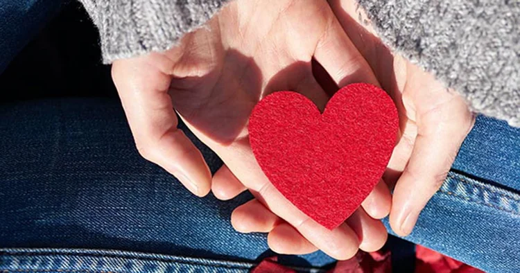Hands holding a red heart