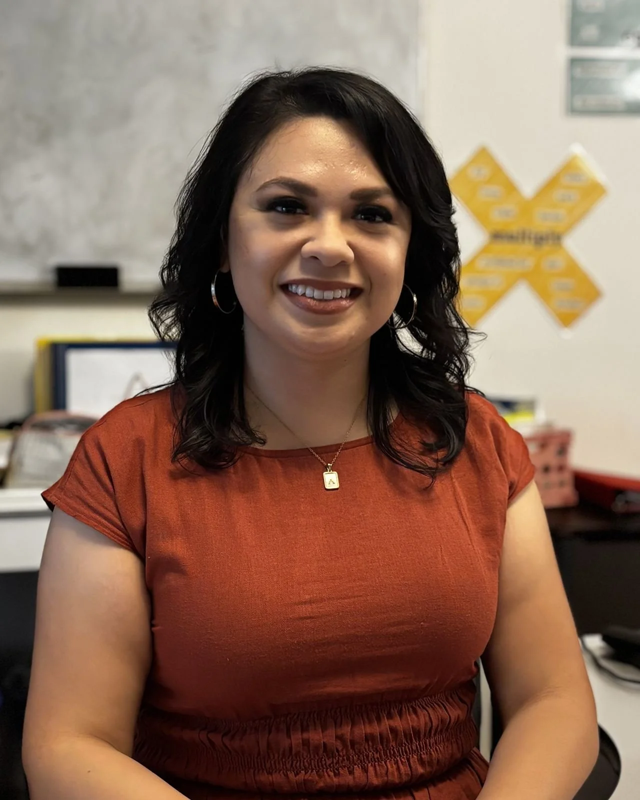 Ashley Guillen, sitting at her desk in a classroom