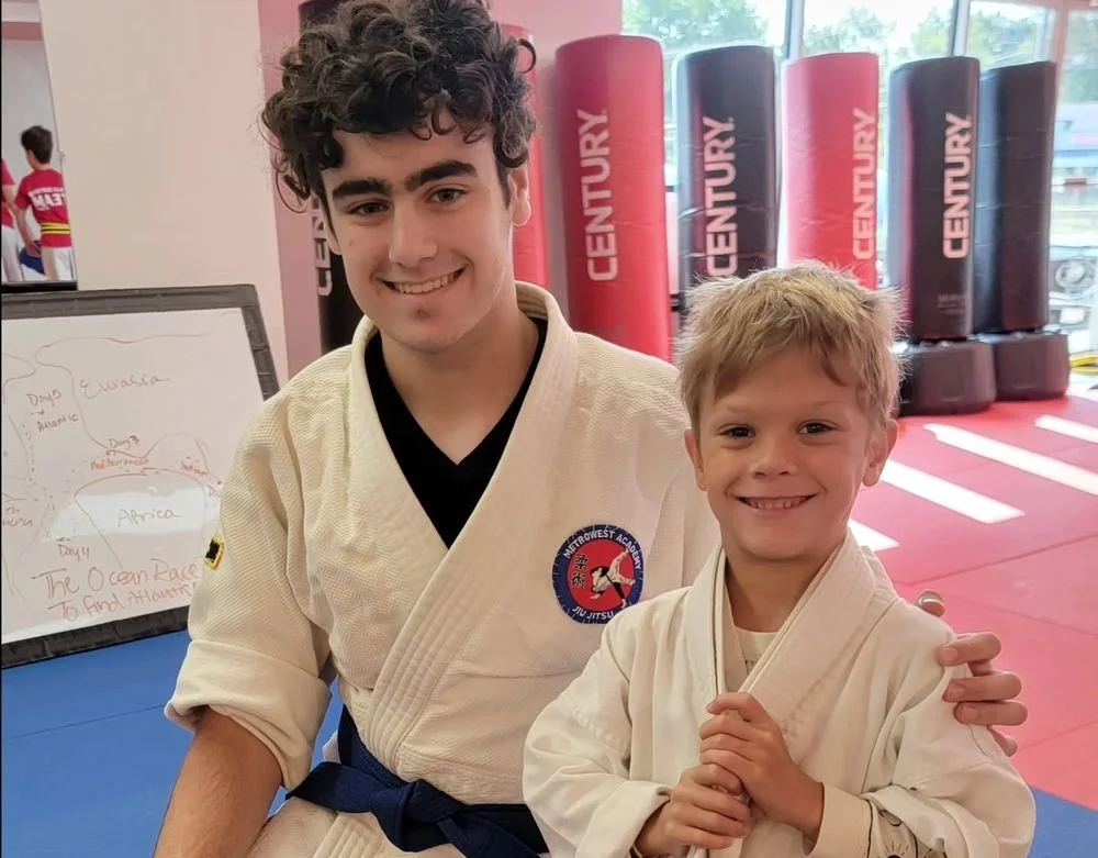 A coach and Kids student smiling together at the Academy