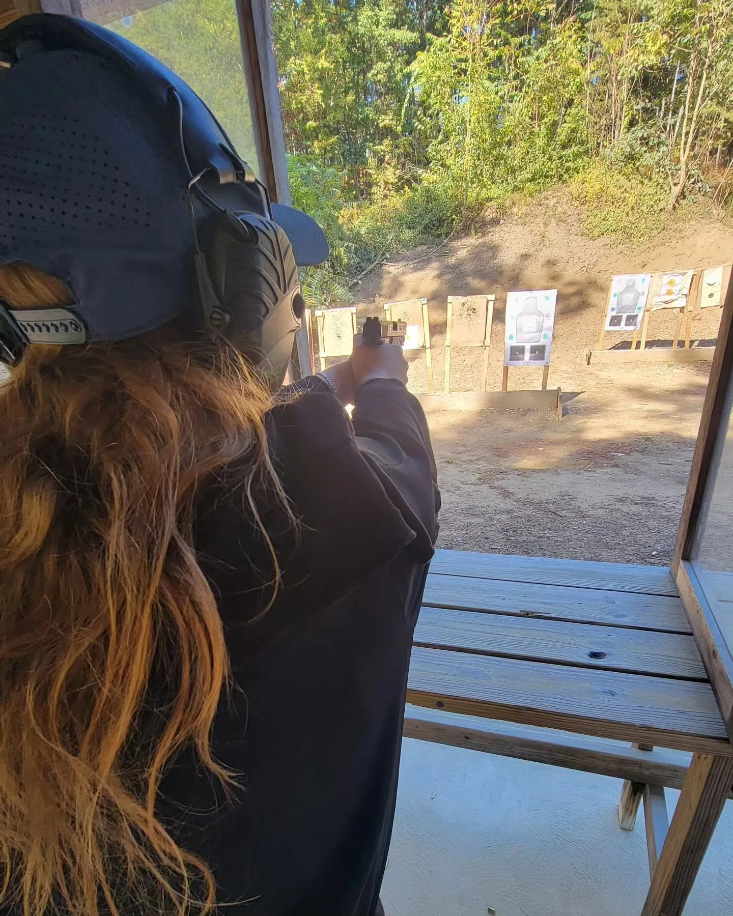 A view from behind a participant toward targets at an outdoor range
