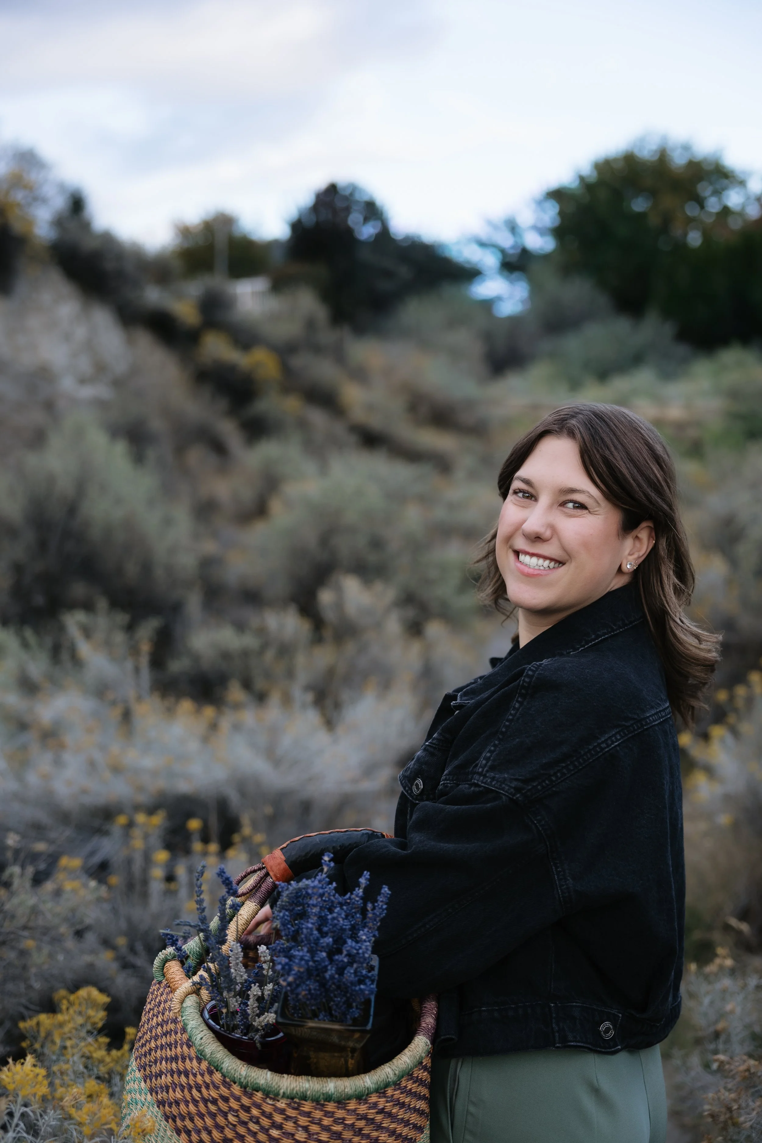 Brooklyn Cook, Orofacial Myofunctional Therapist, holding a basket of lavender in Penticton