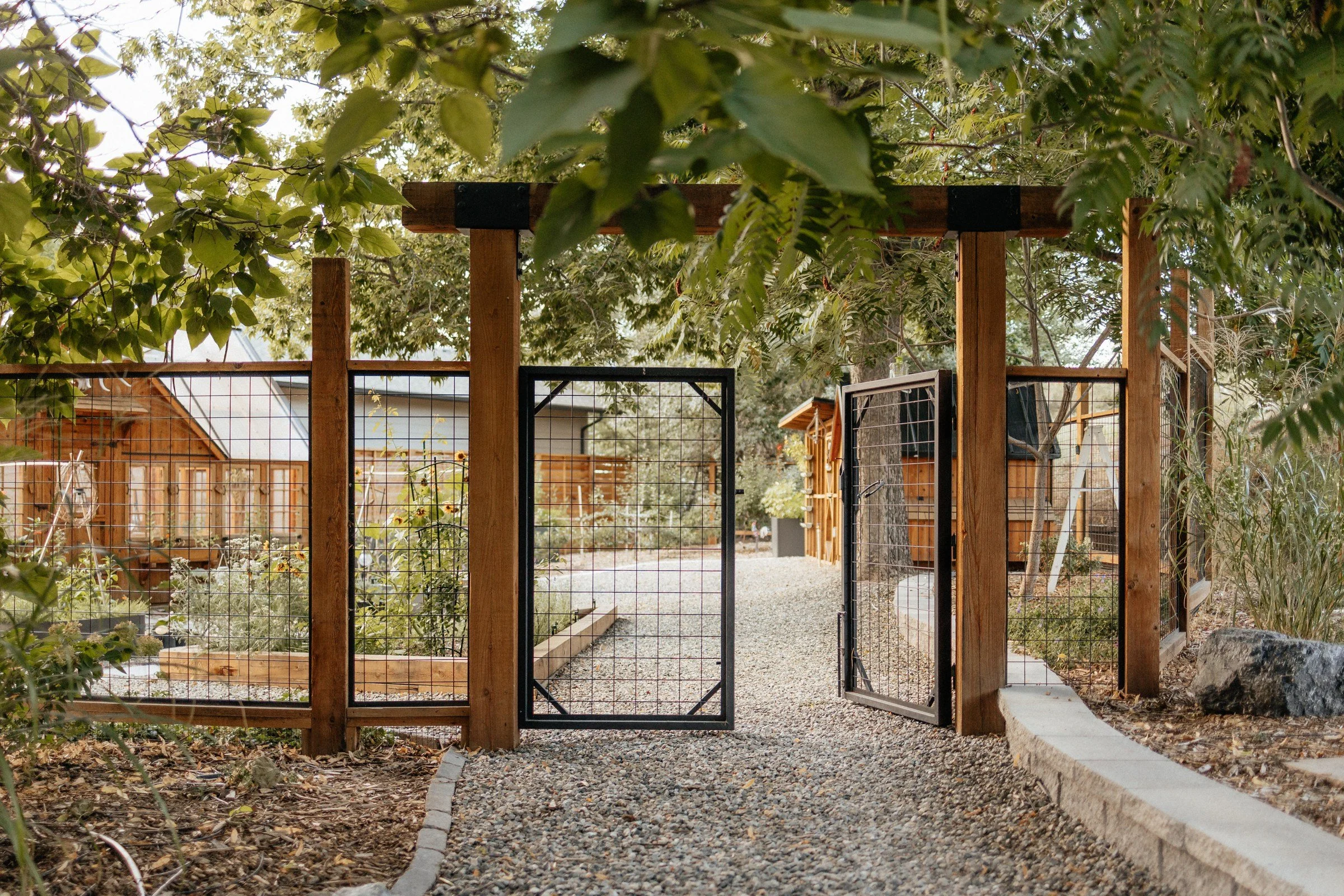 Wooden garden gate opening toward the farm garden