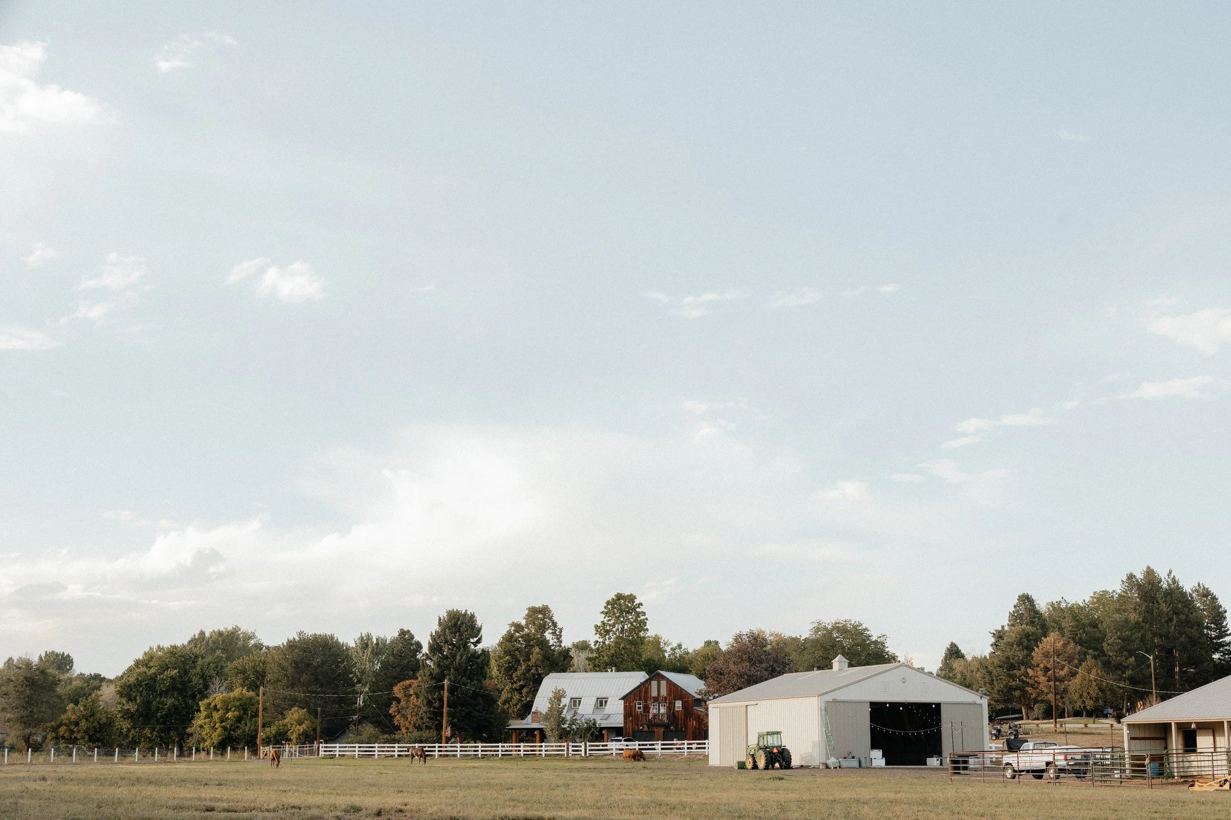 Wide view of the farm pasture, buildings and Colorado sky