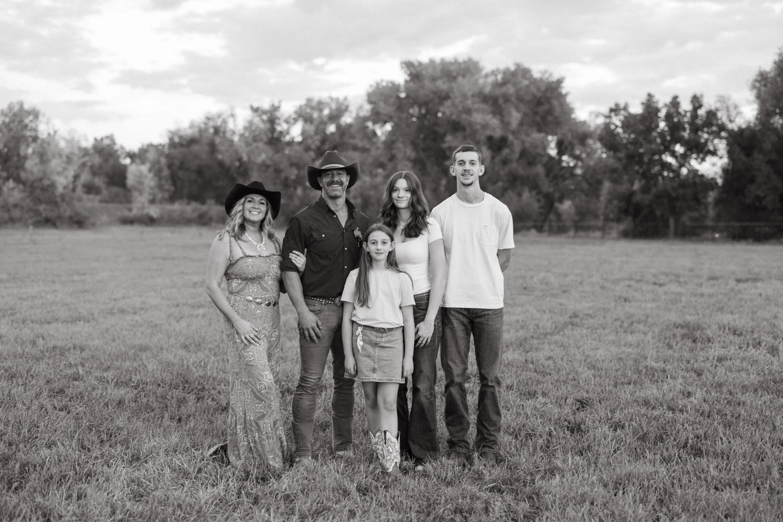 Amy, Tyler and their three children together in the farm pasture