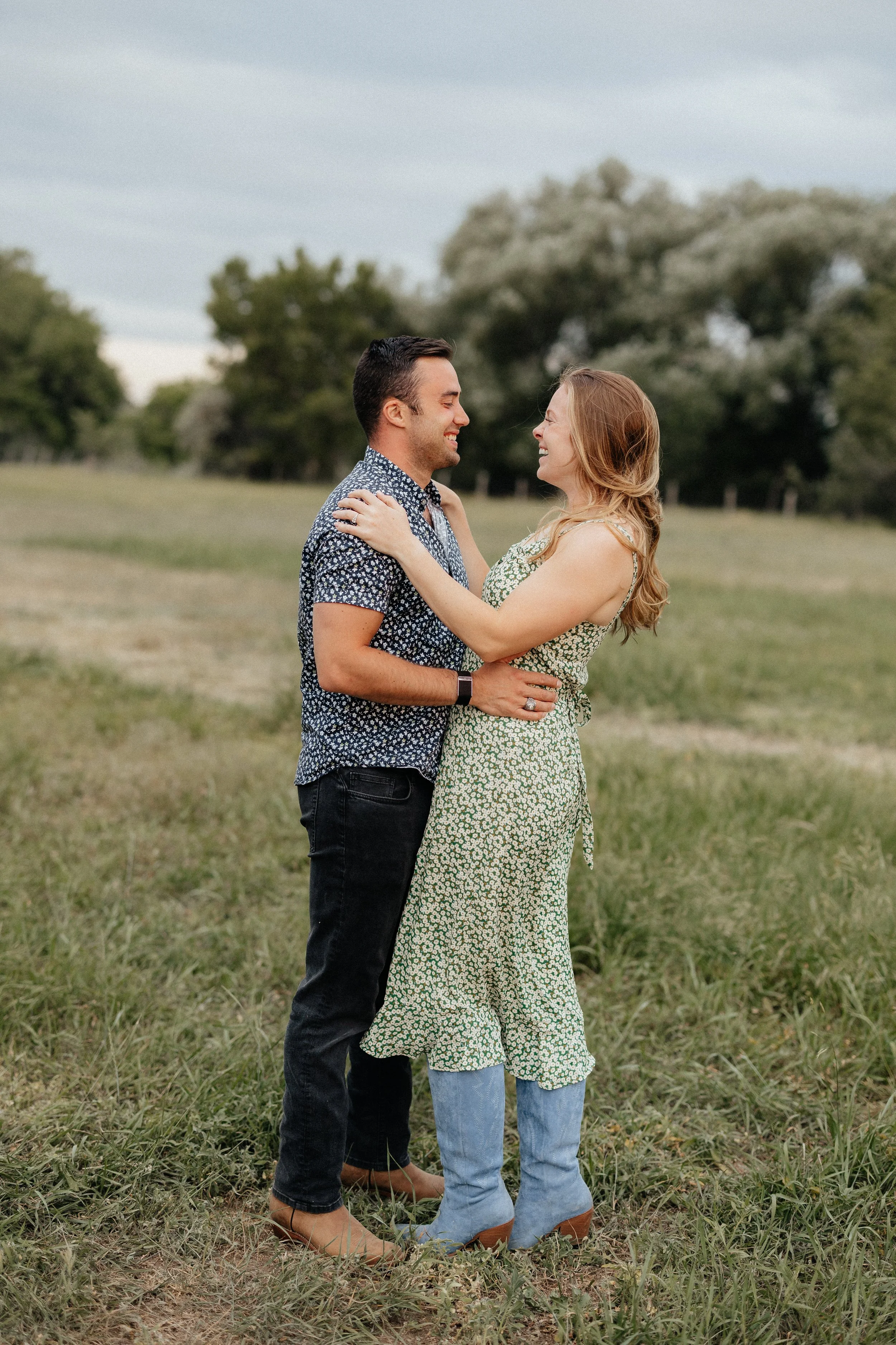 Couple embracing in the farm pasture