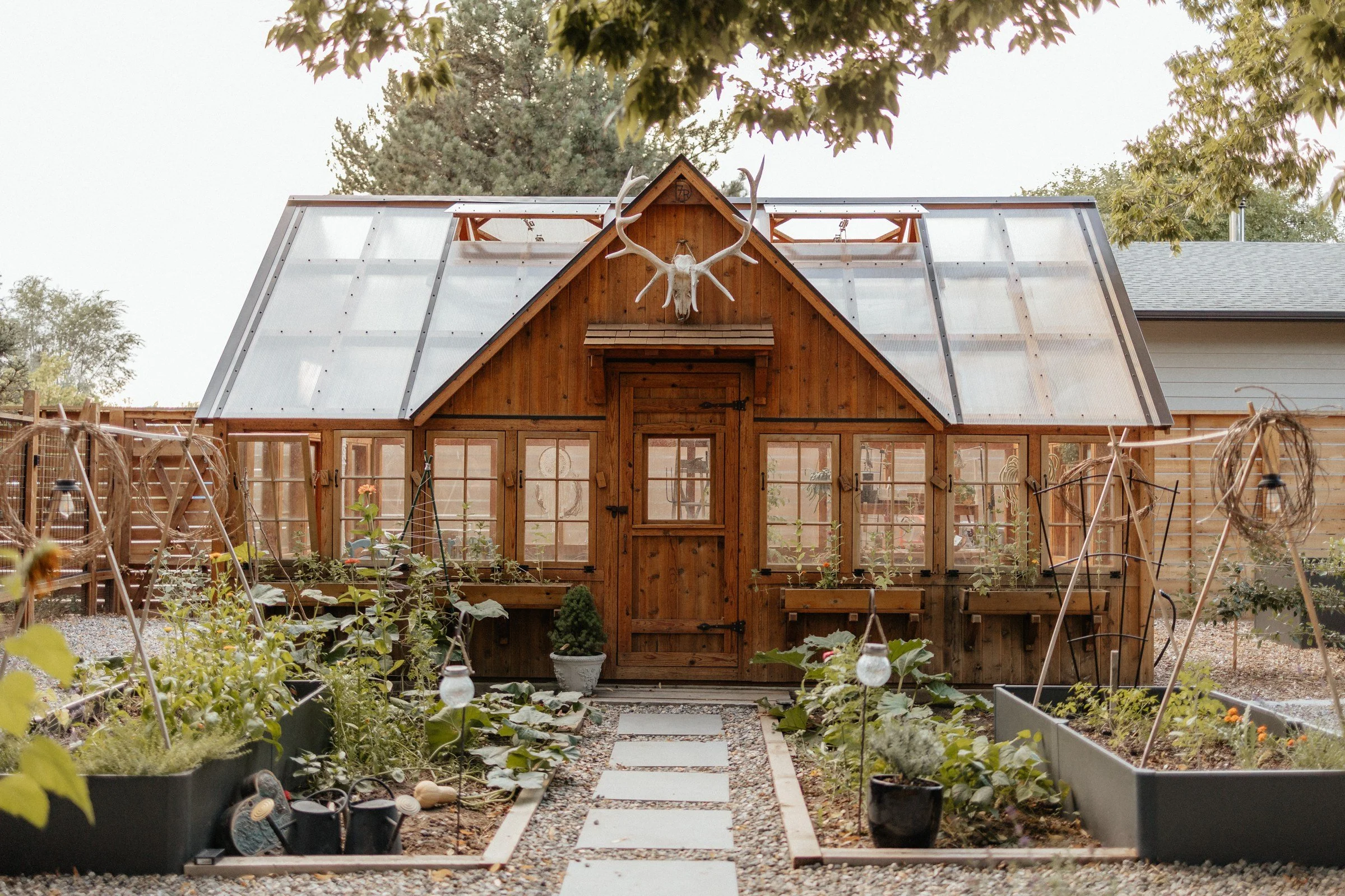The farm greenhouse surrounded by garden planting