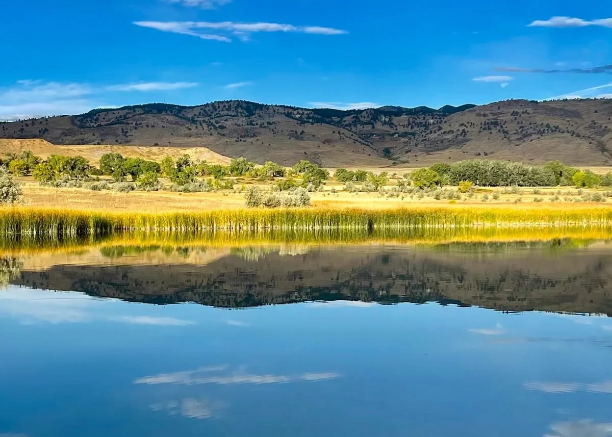 Colorado foothills reflected in a calm lake