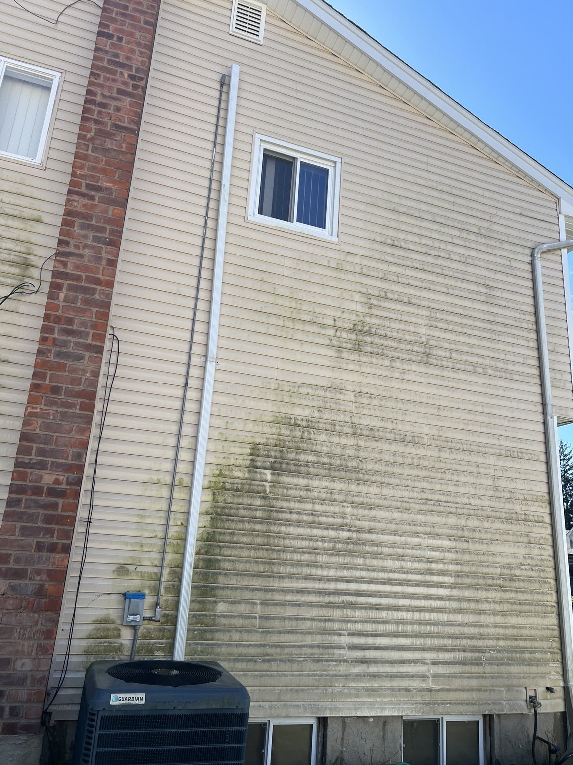 The same house siding before cleaning